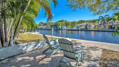 two chairs sitting next to a body of water at Casa Verde - Wilton Manors - Pool in Fort Lauderdale