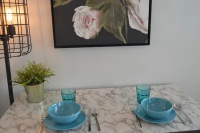 a table with two blue bowls and glasses on it at WATERFRONT STUDIO COZY WITH WATERVIEWs in Miami Beach