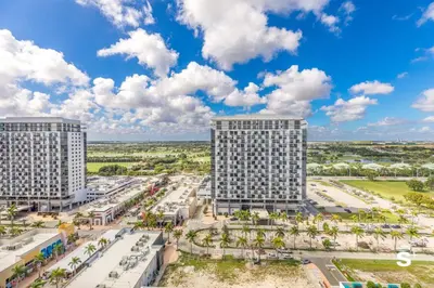 an aerial view of three tall buildings at Doral 2BD Condo with Skyline Views and Fitness Center in Miami