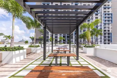 a picnic table on the roof of a building at Modern 1BR in Downtown Doral - Free Parking and Wellness Amenities in Miami