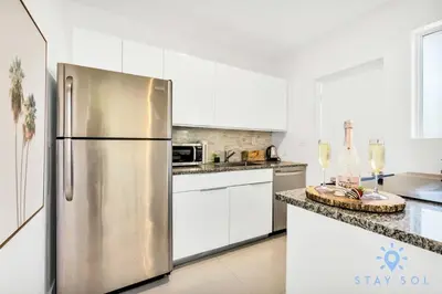 a stainless steel refrigerator in a kitchen with white cabinets at 809 Complex in Hollywood