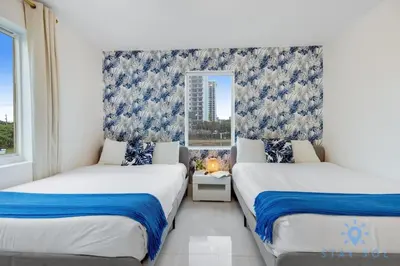 two beds in a room with a window at 809 Complex in Hollywood