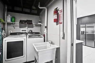 a small kitchen with a stove and a sink at WALK to Hollywood Beach Stylish 5BR and 4BA Villa in Hollywood