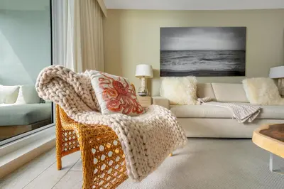 a living room with a chair and a couch at Stunning Oceanfront 1BR in the 1 Hotel in Miami Beach