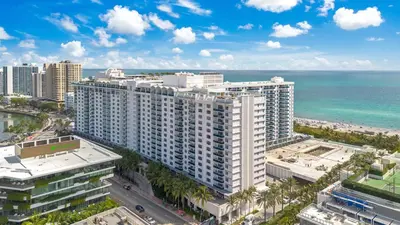 an aerial view of a large building next to the ocean at Stunning Oceanfront 1BR in the 1 Hotel in Miami Beach
