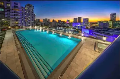 a large swimming pool on the roof of a building at 3BR Skyline Luxury with a 100 inch TV, Balcony & Prime Miami Location in Miami