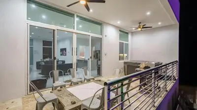 a balcony with chairs and a table in a room at Villa Azul Luxe Retreat in Fort Lauderdale