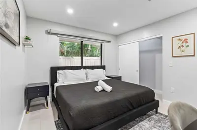 a bedroom with a large bed and a window at Lakefront Villa Tropical Backy in North Miami Beach