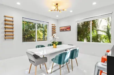 a dining room with a white table and chairs at Brand new Luxurious Villa in Hollywood