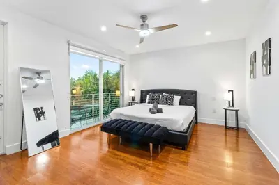 a bedroom with a bed and a ceiling fan at One and only New Villa Heated Pool Jacuzzi in Hollywood