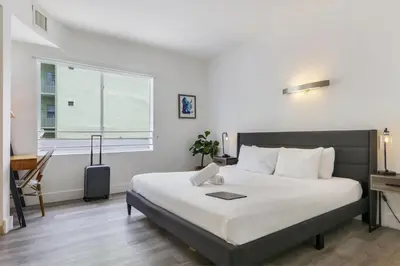 a bedroom with a large bed and a window at St Augustine Hotel By At Mine Hospitality in Miami Beach