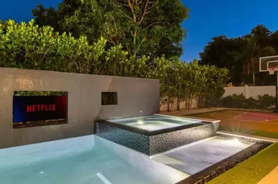 a swimming pool in a backyard with a basketball hoop at New Construction Villa Top Location Jacuzzi Bkb CT in Miami