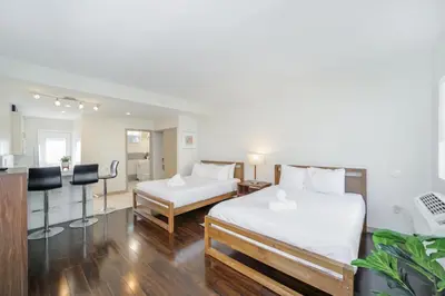 a hotel room with two beds and a kitchen at Casa Colaretta By At Mine Hospitality in Miami Beach
