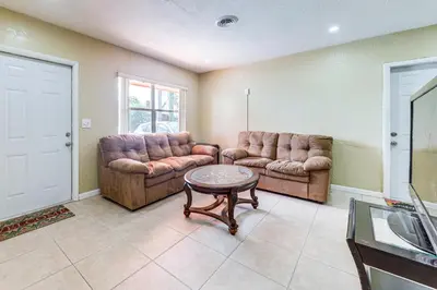 a living room with two couches and a table at 3 Mi to Dania Beach Pier Convenient Apartment! in Dania Beach