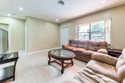 a living room with a couch and a coffee table at 3 Mi to Dania Beach Pier Convenient Apartment! in Dania Beach