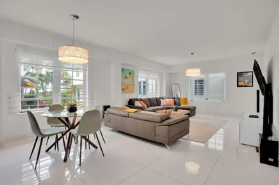 a living room with a couch and a table at 2BR Art Deco Retreat Steps Away from the Beach in Miami Beach