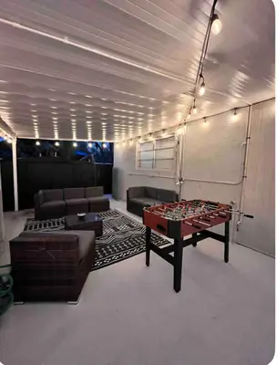 a living room with a ping pong table and couch at Luxury Miami Studio Next to Beach & Airport in Miami