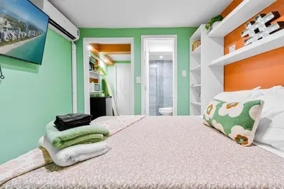 a bedroom with a bed with green and orange walls at Luxury Miami Studio Next to Beach & Airport in Miami