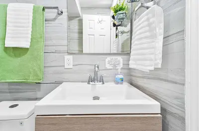 a bathroom with a white sink and a mirror at Luxury Miami Studio Next to Beach & Airport in Miami