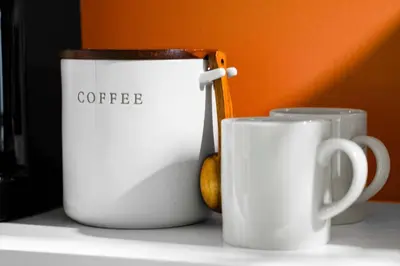 two white coffee cups sitting on a table at Luxury Miami Studio Next to Beach & Airport in Miami