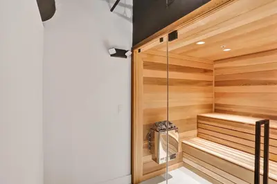 a sauna with wooden walls and a glass door at Stylish Oceanfront 2BR 1 and a half BA Condo with Resort Amenities Pools Gym Sauna 1402 in Miami Beach