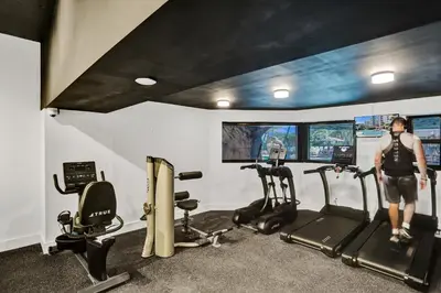 a man standing in a gym with two tread machines at Stylish Oceanfront 2BR 1 and a half BA Condo with Resort Amenities Pools Gym Sauna 1402 in Miami Beach