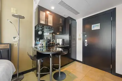 a small bar in a room with a table at Luxury Suite - 3 Min Walk to Miami Beach in Miami Beach