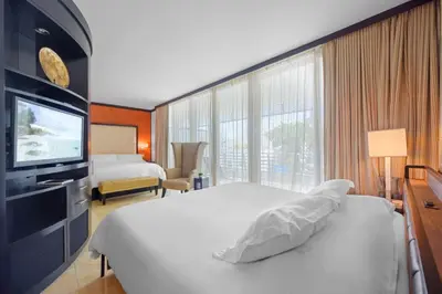 a hotel room with a bed and a television at Luxury Suite - 3 Min Walk to Miami Beach in Miami Beach