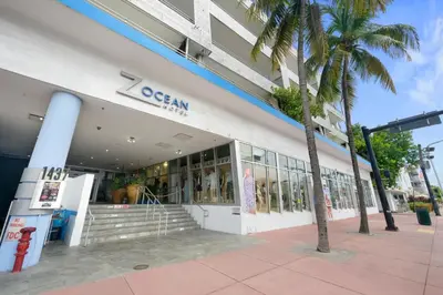 a store with a palm tree in front of a building at Luxury Suite - 3 Min Walk to Miami Beach in Miami Beach