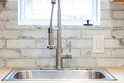 a stainless steel sink in a kitchen with a window at Modern Miami Home minutes to Wynwood & Downtown in Miami