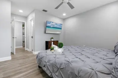 a bedroom with a bed and a ceiling fan at Renovated Home in Hollywood in Hollywood
