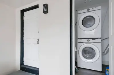 a laundry room with a washer and dryer next to a door at Renovated Home in Hollywood in Hollywood