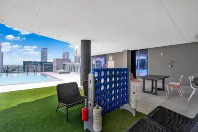 a room with a ping pong table and chairs at Elegant studio in the heart of downtown Miami in Miami