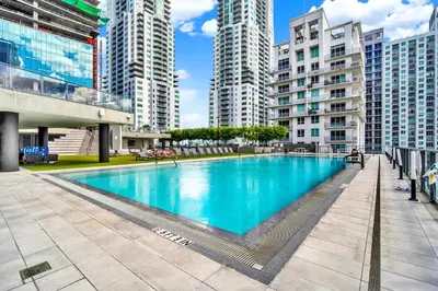 a large swimming pool in a city with tall buildings at Elegant studio in the heart of downtown Miami in Miami