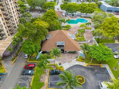 an aerial view of a house with a pool and trees at Urban Escape 2 Bed Unit In Miami near Whole Foods in North Miami