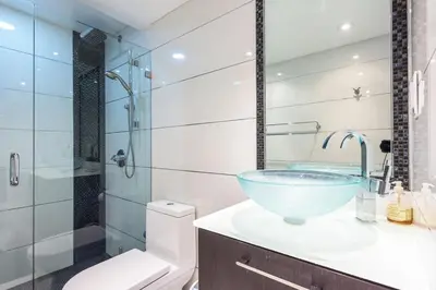 a bathroom with a glass bowl sink and a shower at Large 2 Bedroom Oceanfront at Roney Palace in South Beach in Miami Beach
