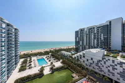 an aerial view of two tall buildings and the beach at Large 2 Bedroom Oceanfront at Roney Palace in South Beach in Miami Beach