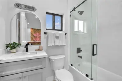 a white bathroom with a toilet and a shower at Casa Bella - New & Stylish Family-Friendly Home in Miami