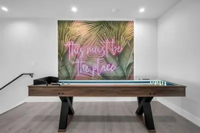 a ping pong table in a room with a painting at Casa Bella - New & Stylish Family-Friendly Home in Miami