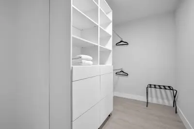 a room with white cabinets and a black chair at Casa Amoret - Brand New Family-Friendly Retreat in Miami
