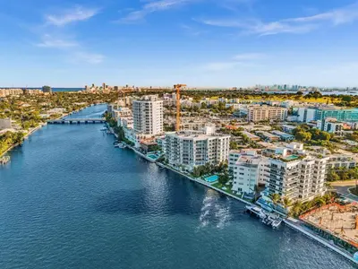 an aerial view of a city with a river and buildings at Waterfront Luxury Kosher Condo with Rooftop Pool, Bay Harbor Islands in Miami Beach