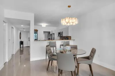 a dining room and kitchen with a table and chairs at Waterview Luxury 2-Bedroom Condo Sunny Isles Beach in Sunny Isles Beach