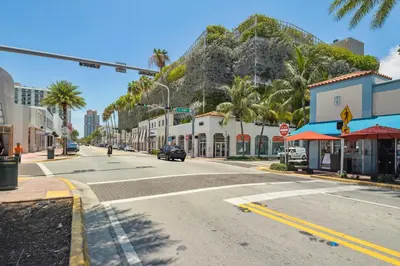 an empty street in front of a mountain at 713 Miami Beach Apartments in Miami Beach