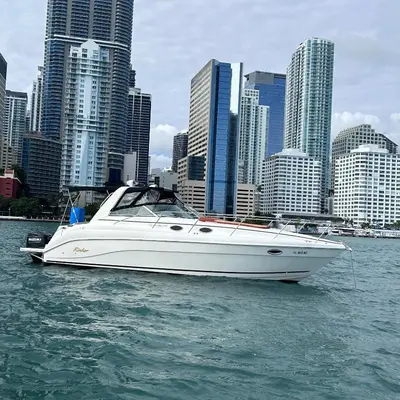 a white boat in the water in front of a city at Party On The Seas in Miami