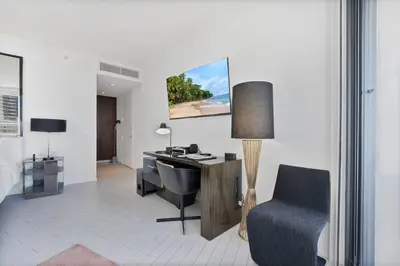 an office with a desk and a chair in a room at Oceanfront Elegance at W Hotel in Miami Beach