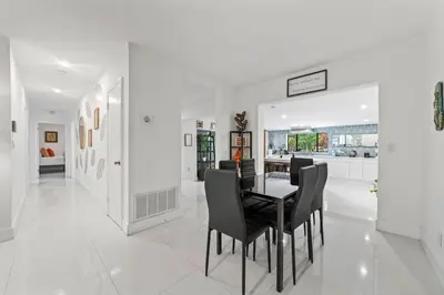 a dining room with a table and black chairs at Oasis with Pool & Cold Plunge-Near Beach & Nightlife in Fort Lauderdale