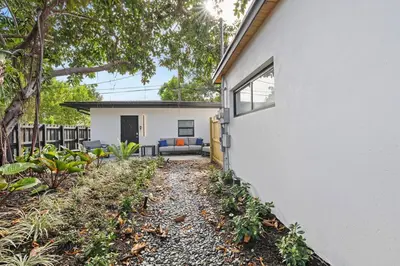 a white house with a couch in a yard at Perfect stay for 2-Walk to Wilton Drive-Shops &bars in Fort Lauderdale