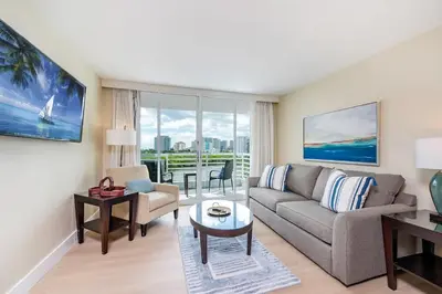 a living room with a couch and a table at Amazing Intracoastal Views - Walk to the Beach! in Fort Lauderdale