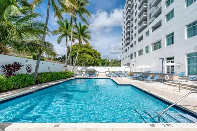 a swimming pool in front of a building at Amazing Intracoastal Views - Walk to the Beach! in Fort Lauderdale