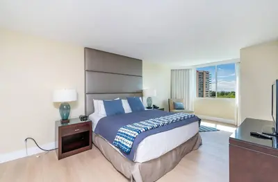 a bedroom with a large bed and a television at Amazing Intracoastal Views - Walk to the Beach! in Fort Lauderdale